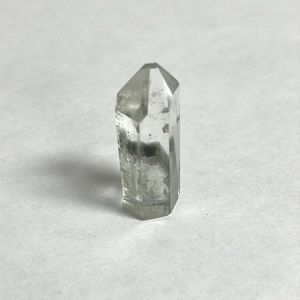 Quartz Crystal - 1.5 inches by half inch wide. Has small chip on tip.